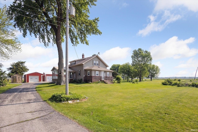 29351 Darden Rd, New Carlisle, IN 46552 - view of front of home featuring an outdoor structure, a garage, a chimney, and a front lawn