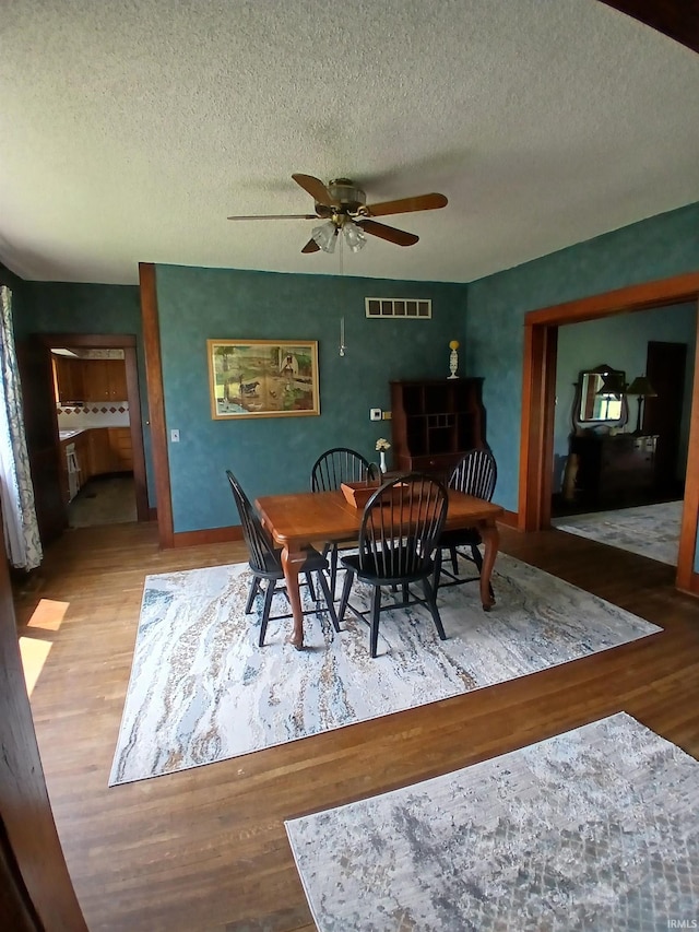 7086 S 200 E, Macy, IN 46951 - dining space featuring wood finished floors, ceiling fan, and a textured ceiling