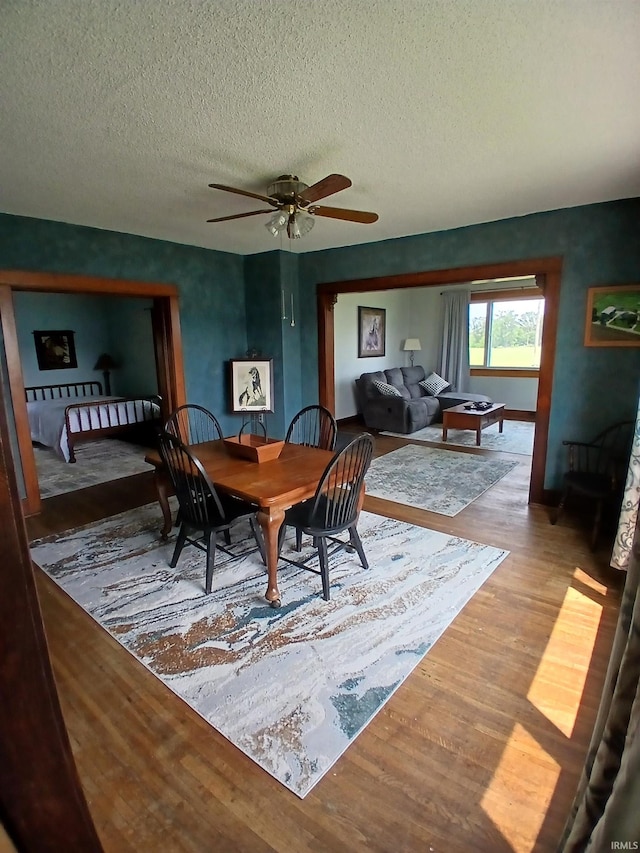 7086 S 200 E, Macy, IN 46951 - dining room featuring wood finished floors, ceiling fan, and a textured ceiling