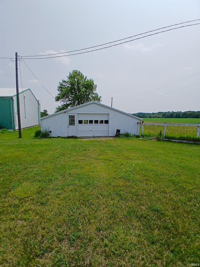 7086 S 200 E, Macy, IN 46951 - view of green lawn featuring a detached garage and an outbuilding