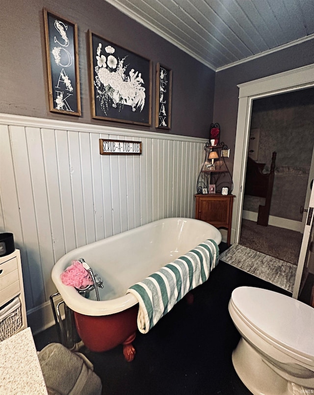 715 SE 2nd St, Washington, IN 47501 - bathroom featuring a freestanding tub, a wainscoted wall, and crown molding