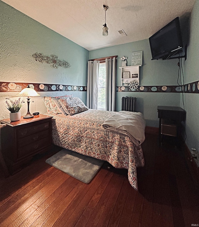 715 SE 2nd St, Washington, IN 47501 - bedroom featuring wood-type flooring, a textured ceiling, and a textured wall