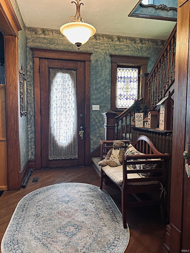 715 SE 2nd St, Washington, IN 47501 - foyer entrance featuring stairs, wallpapered walls, and wood finished floors