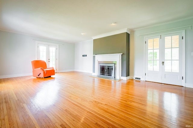 2801 W University Ave, Muncie, IN 47304 - unfurnished living room featuring crown molding, wood finished floors, a glass covered fireplace, and french doors