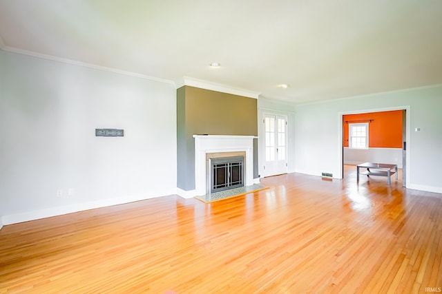 2801 W University Ave, Muncie, IN 47304 - unfurnished living room with light wood-style floors, ornamental molding, and a fireplace