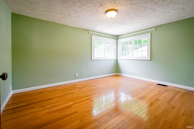 2801 W University Ave, Muncie, IN 47304 - unfurnished room with hardwood / wood-style flooring and a textured ceiling
