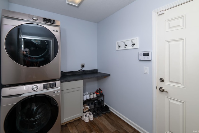 1811 Apopka Way, Fort Wayne, IN 46814 - laundry room featuring stacked washer and clothes dryer, cabinet space, and dark wood-type flooring