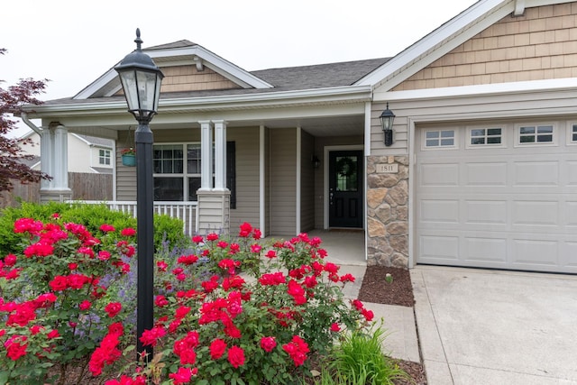 1811 Apopka Way, Fort Wayne, IN 46814 - view of exterior entry featuring covered porch, an attached garage, and stone siding