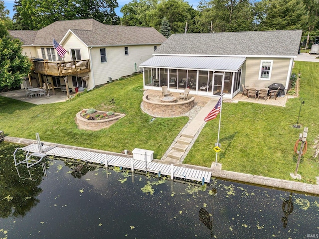 51 Ems W26 Ln, North Webster, IN 46555 - back of property featuring a sunroom, a patio, and a lawn