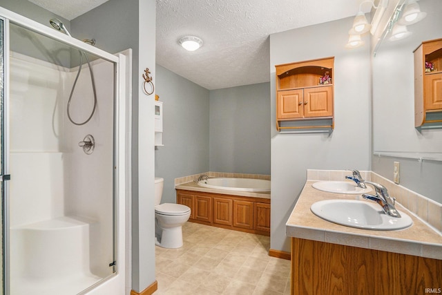 51 Ems W26 Ln, North Webster, IN 46555 - full bath with a shower stall, a textured ceiling, double vanity, and a garden tub