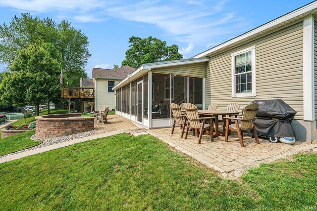 51 Ems W26 Ln, North Webster, IN 46555 - back of house with a patio, a sunroom, a lawn, and a wooden deck