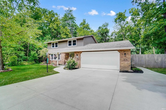 5820 Rosedale Dr, Fort Wayne, IN 46804 - traditional-style home with concrete driveway, a garage, brick siding, and view of wooded area
