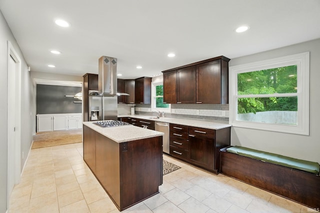 5820 Rosedale Dr, Fort Wayne, IN 46804 - kitchen with island range hood, stainless steel appliances, a kitchen island, dark brown cabinetry, and decorative backsplash
