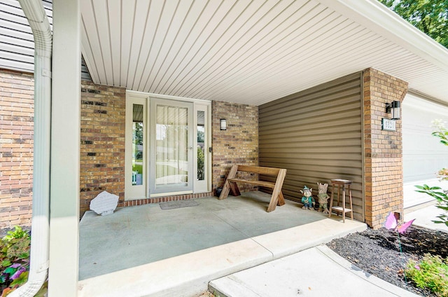 5820 Rosedale Dr, Fort Wayne, IN 46804 - property entrance with brick siding, an attached garage, and covered porch