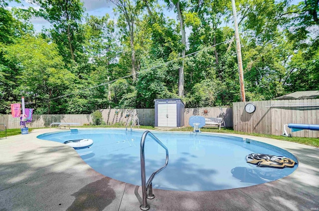 5820 Rosedale Dr, Fort Wayne, IN 46804 - view of pool with a fenced backyard, a shed, view of wooded area, a diving board, and a patio area