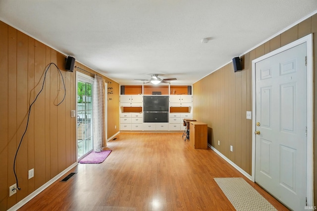 5820 Rosedale Dr, Fort Wayne, IN 46804 - foyer entrance featuring light wood-type flooring, a ceiling fan, wooden walls, and crown molding