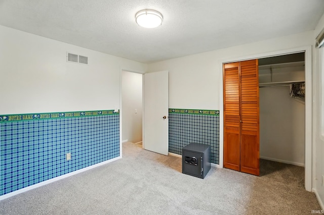 5820 Rosedale Dr, Fort Wayne, IN 46804 - unfurnished bedroom featuring carpet flooring, a closet, wainscoting, and a textured ceiling
