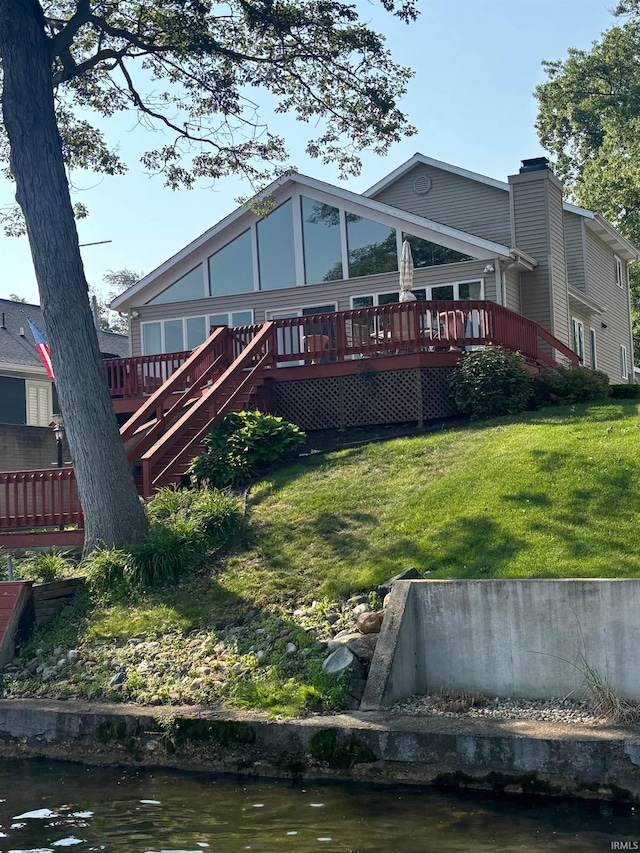 2910 Country Club Dr, Rochester, IN 46975 - rear view of house featuring a deck with water view, stairs, and a yard