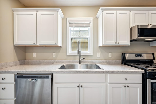1729 Carter Ct, Mishawaka, IN 46545 - kitchen with appliances with stainless steel finishes, white cabinetry, and light countertops