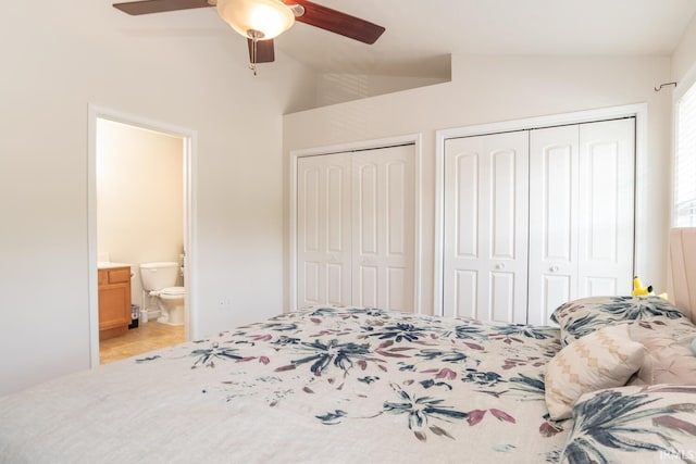 1250 W Adams Hill Cir Unit 104, Bloomington, IN 47403 - tiled bedroom with lofted ceiling, two closets, ensuite bath, and ceiling fan