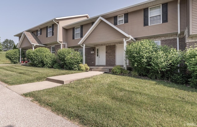 1250 W Adams Hill Cir Unit 104, Bloomington, IN 47403 - view of front of home with brick siding and a front yard