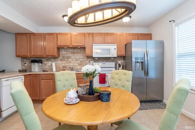 1250 W Adams Hill Cir Unit 104, Bloomington, IN 47403 - kitchen featuring white appliances, light tile patterned floors, backsplash, and light countertops