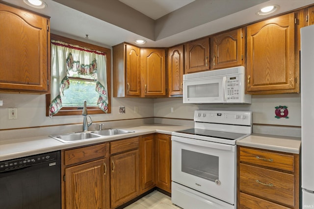 29230 Walerko Dr, Elkhart, IN 46514 - kitchen featuring white appliances, brown cabinetry, light countertops, and recessed lighting