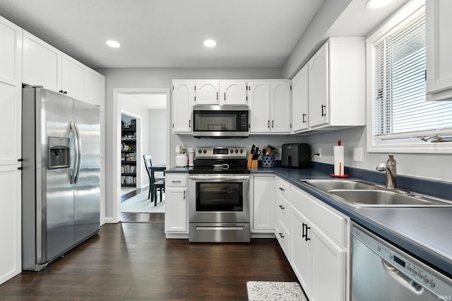 10412 Kentfield Pl, Fort Wayne, IN 46818 - kitchen with appliances with stainless steel finishes, white cabinetry, recessed lighting, dark wood-type flooring, and dark countertops