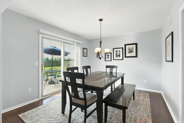 10412 Kentfield Pl, Fort Wayne, IN 46818 - dining room with dark wood finished floors, a textured ceiling, and a chandelier