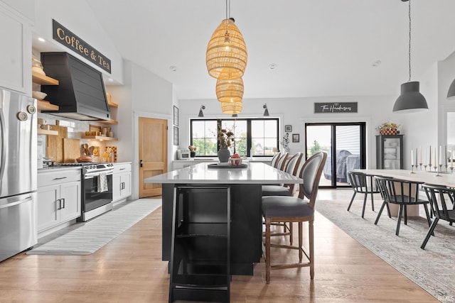11306 Fishers Pond, Middlebury, IN 46540 - kitchen with open shelves, appliances with stainless steel finishes, premium range hood, a center island, and healthy amount of natural light