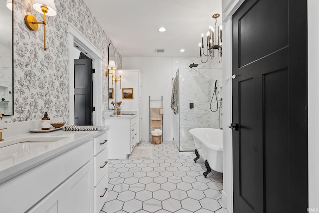 11306 Fishers Pond, Middlebury, IN 46540 - full bathroom with a marble finish shower, two vanities, a chandelier, wallpapered walls, and a freestanding bath