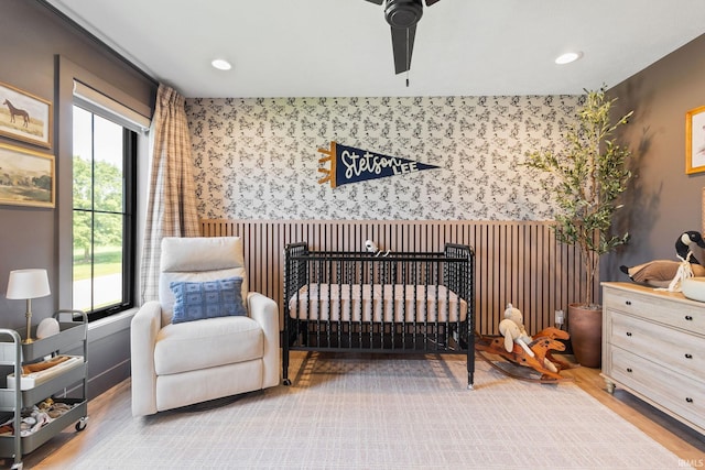 11306 Fishers Pond, Middlebury, IN 46540 - bedroom featuring wallpapered walls, a nursery area, wood finished floors, wainscoting, and recessed lighting