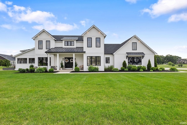 11306 Fishers Pond, Middlebury, IN 46540 - modern inspired farmhouse featuring a standing seam roof, a metal roof, a front lawn, and roof with shingles
