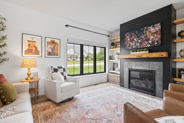 11306 Fishers Pond, Middlebury, IN 46540 - living area featuring wood finished floors and a glass covered fireplace