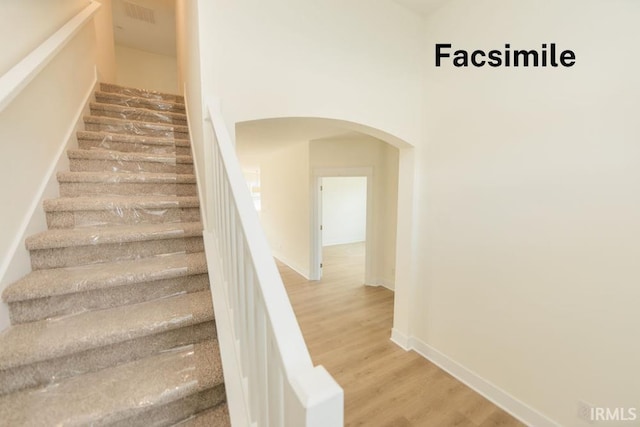 4651 S Quinn Dr, Bloomington, IN 47403 - stairs with arched walkways and wood finished floors