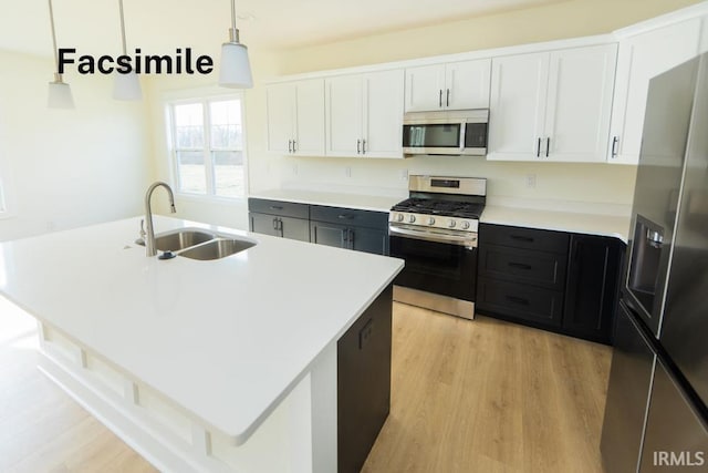 4651 S Quinn Dr, Bloomington, IN 47403 - kitchen with appliances with stainless steel finishes, white cabinetry, light wood finished floors, decorative light fixtures, and light countertops