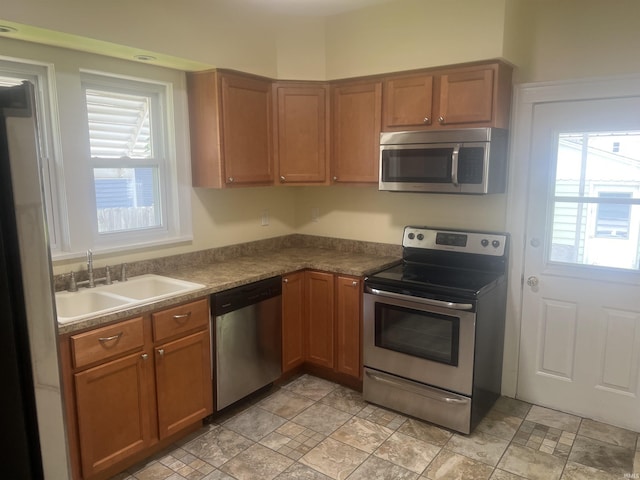 1715 Everett St, Lafayette, IN 47905 - kitchen featuring stainless steel appliances, dark countertops, and brown cabinets