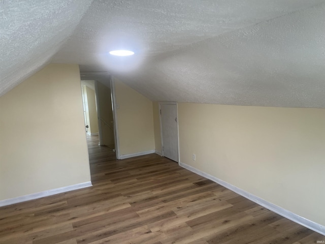 1715 Everett St, Lafayette, IN 47905 - bonus room featuring a textured ceiling, wood finished floors, and vaulted ceiling