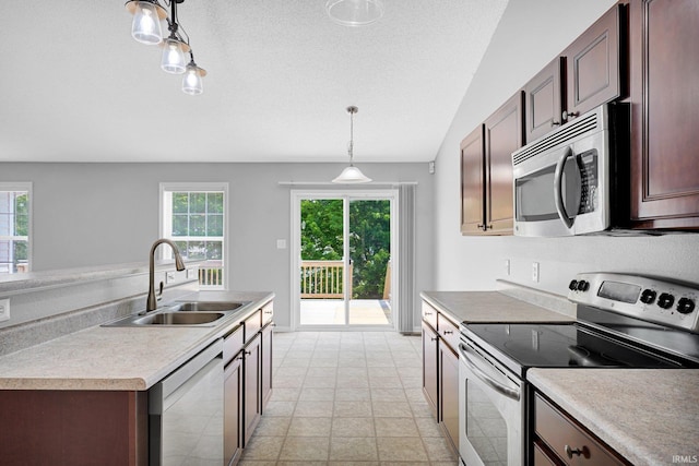 3549 S Wickens St, Bloomington, IN 47403 - kitchen featuring stainless steel appliances, hanging light fixtures, light countertops, vaulted ceiling, and a textured ceiling