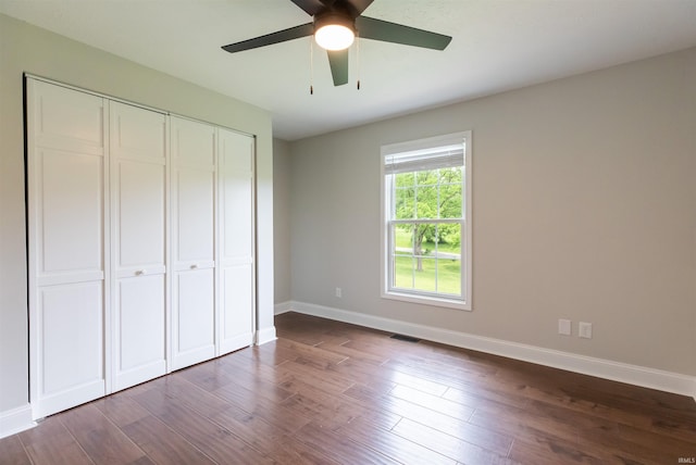 7486 S Ketcham Rd, Bloomington, IN 47403 - unfurnished bedroom with a closet, dark wood-type flooring, and ceiling fan