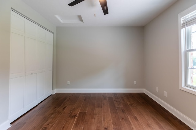 7486 S Ketcham Rd, Bloomington, IN 47403 - unfurnished bedroom featuring dark wood-style floors, multiple windows, and a closet