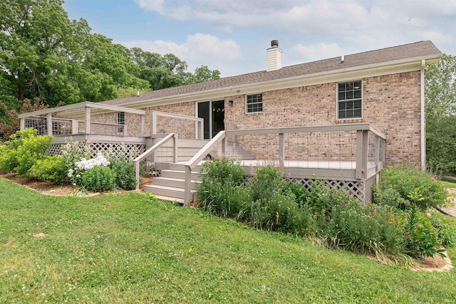 7486 S Ketcham Rd, Bloomington, IN 47403 - back of property featuring brick siding, a wooden deck, and a yard