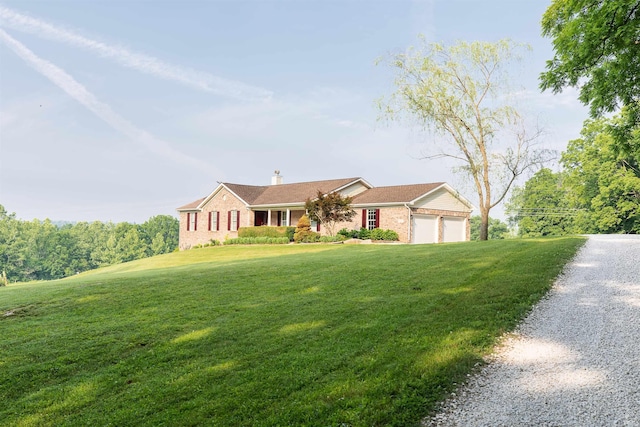 7486 S Ketcham Rd, Bloomington, IN 47403 - single story home with brick siding, an attached garage, a chimney, and a front lawn
