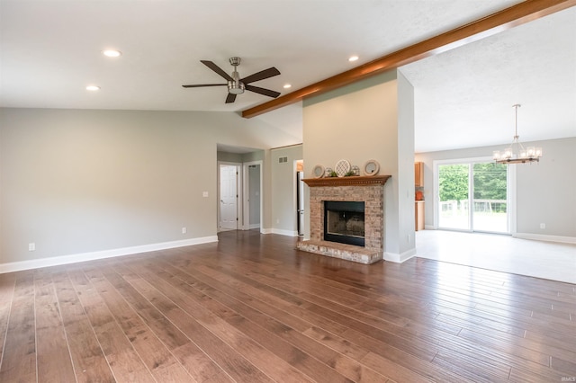 7486 S Ketcham Rd, Bloomington, IN 47403 - unfurnished living room with a ceiling fan, a chandelier, a fireplace, recessed lighting, and wood finished floors