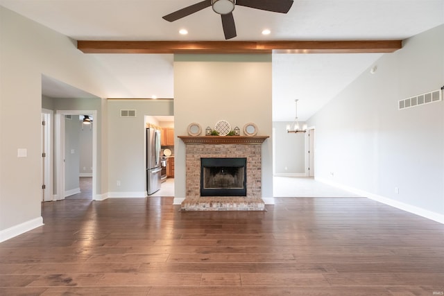 7486 S Ketcham Rd, Bloomington, IN 47403 - unfurnished living room featuring ceiling fan, hardwood / wood-style flooring, a fireplace, recessed lighting, and a chandelier