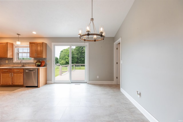 7486 S Ketcham Rd, Bloomington, IN 47403 - kitchen with dishwasher, a chandelier, decorative backsplash, and pendant lighting