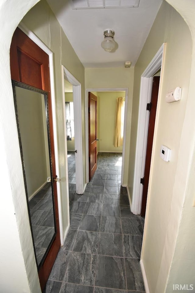 209 E Plum St, Linden, IN 47955 - corridor featuring dark stone finish flooring and baseboards