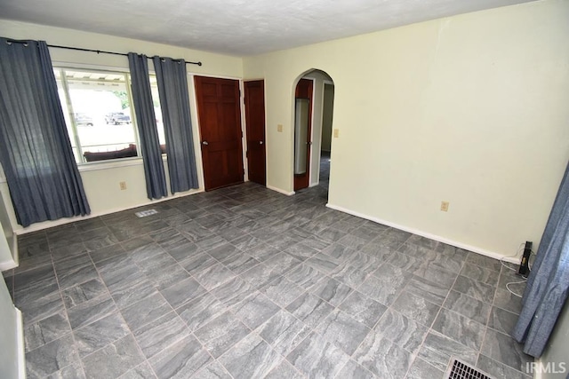 209 E Plum St, Linden, IN 47955 - empty room with arched walkways and baseboards