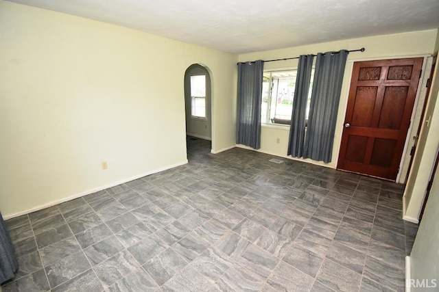 209 E Plum St, Linden, IN 47955 - spare room featuring arched walkways and baseboards