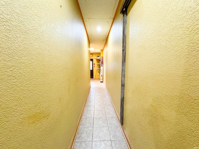 101 W Main St, Syracuse, IN 46567 - hallway featuring a textured wall, light tile patterned floors, and a drop ceiling